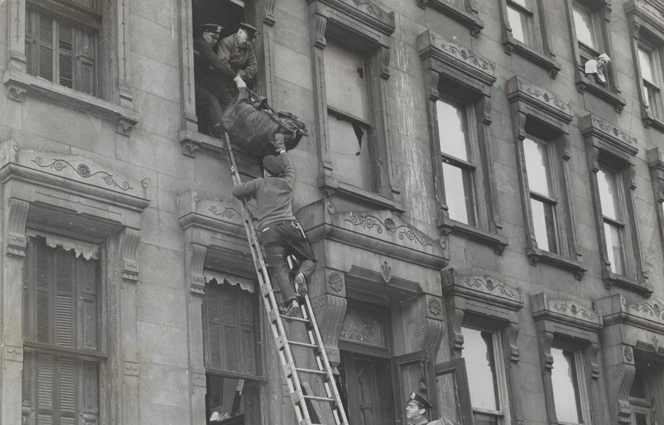 Rundown three-story brownstone house at Fifth Avenue and 128th street