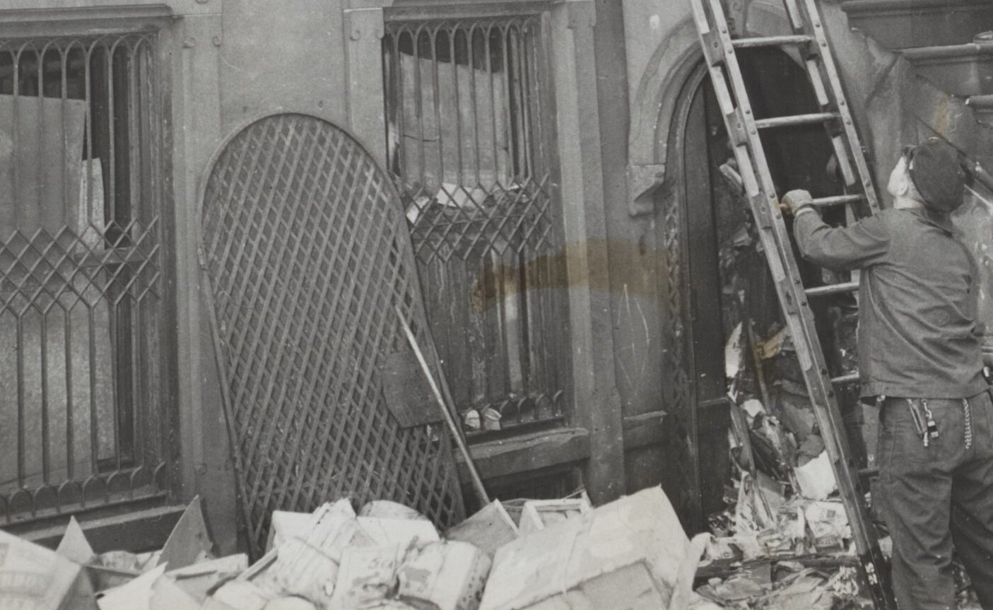 Rundown three-story brownstone house at Fifth Avenue and 128th street