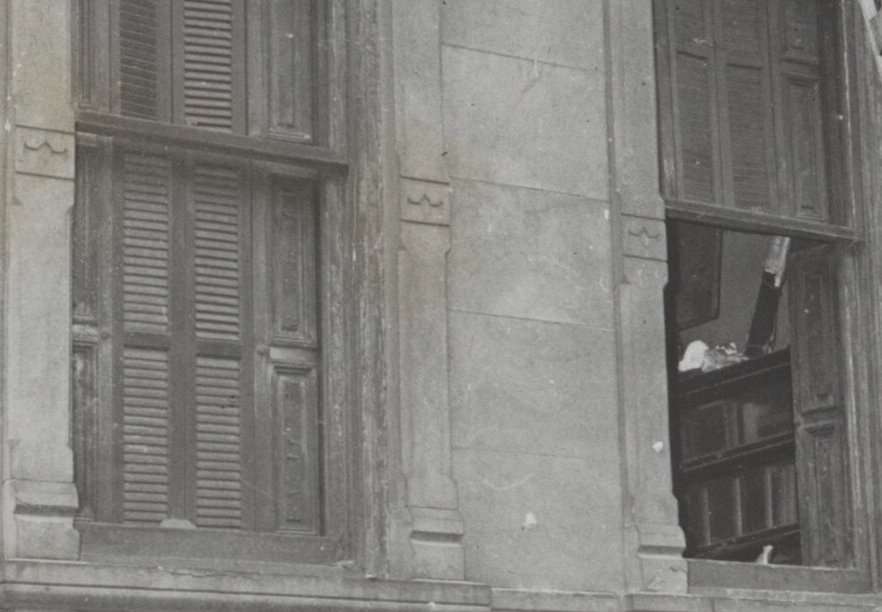 Windows of a rundown three-story brownstone house at Fifth Avenue and 128th street