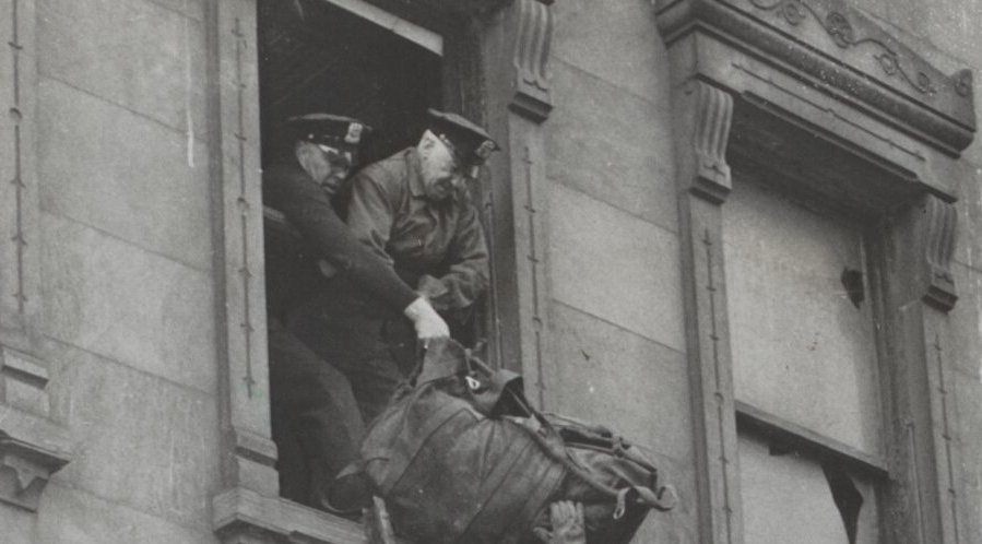 Through A Second Floor Window, Policemen Remove The Body Of Homer Collyer