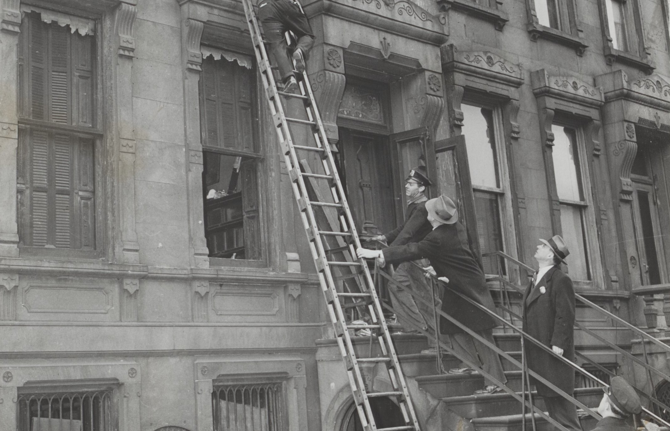 Rundown three-story brownstone house at Fifth Avenue and 128th street