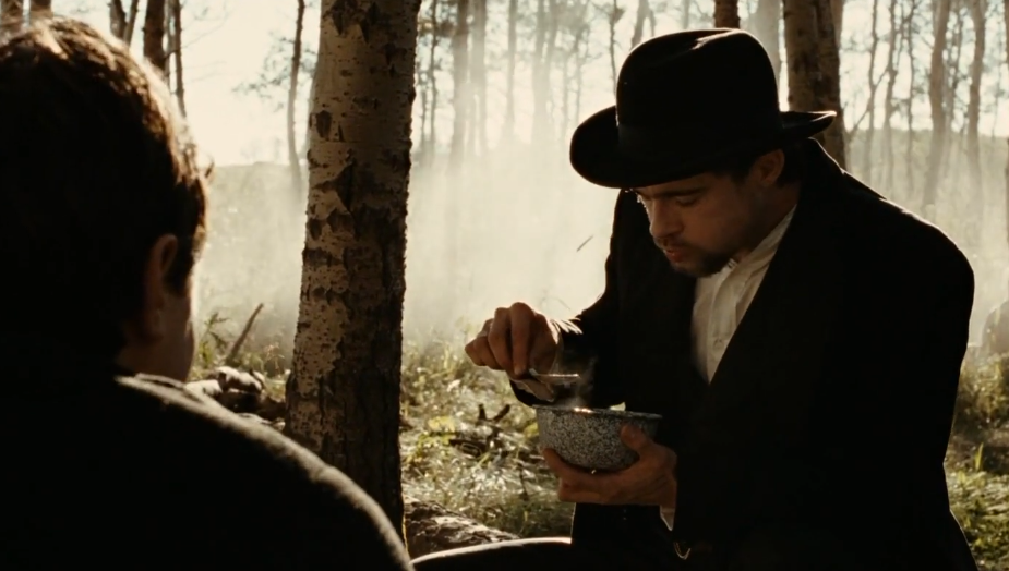 Brad Pitt as Jesse James eating a meal