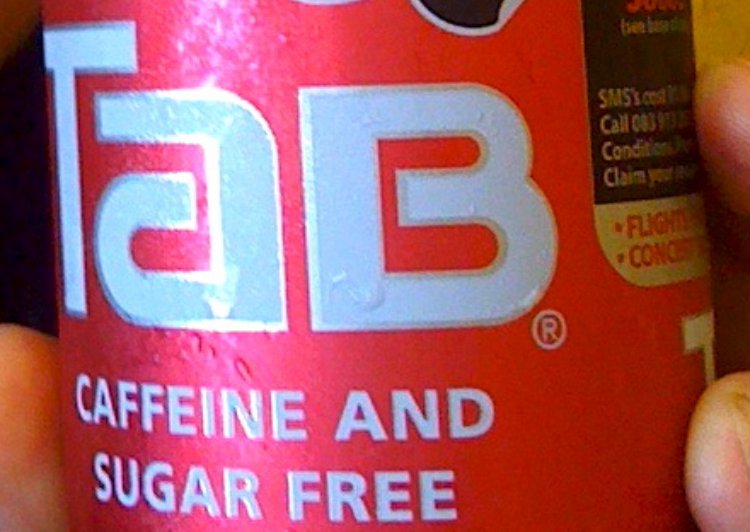 Person holding Tab Cola Soft Drink