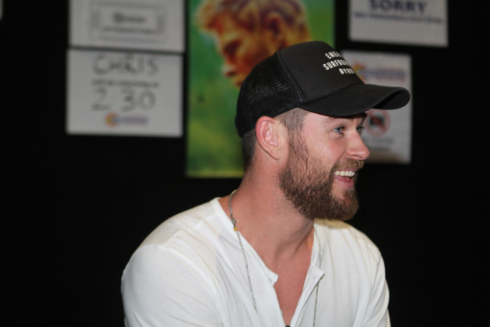 Chris Hemsworth wearing white shirt and black cap