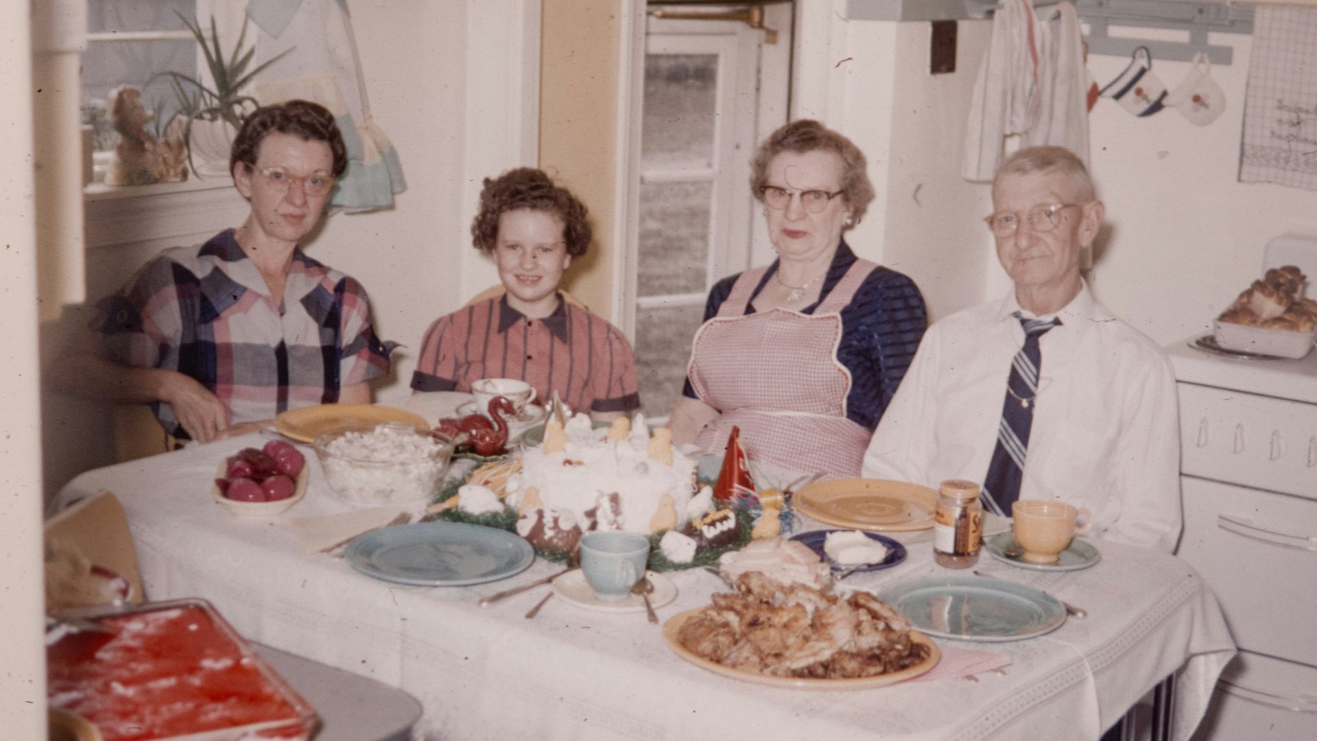 a group of people sitting around a table with food on it