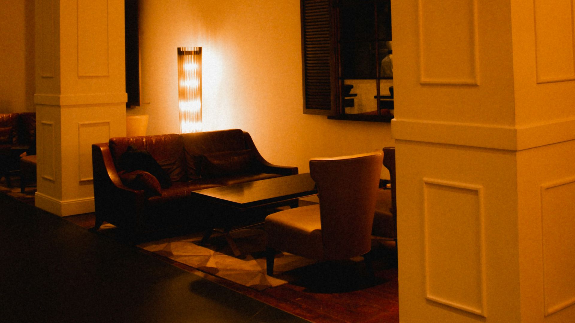 black sofa chair near white wooden cabinet