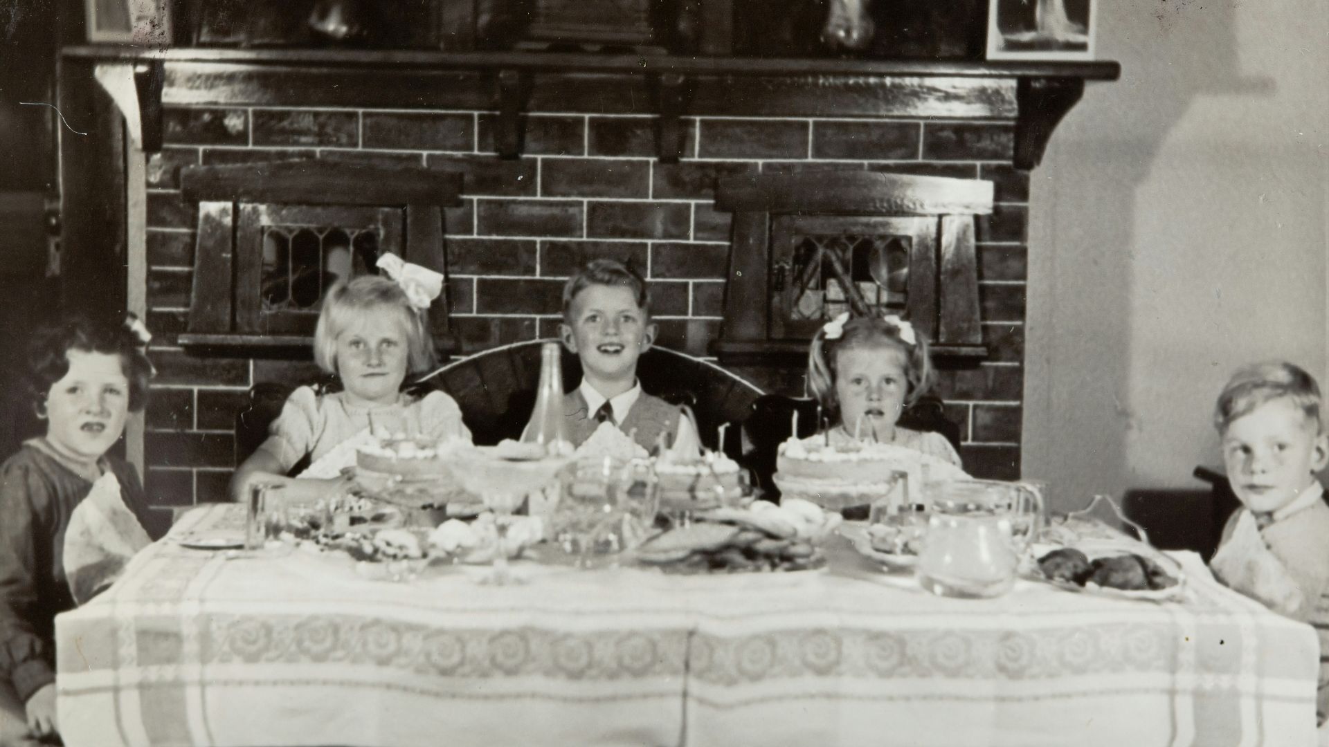 grayscale photo of family on table