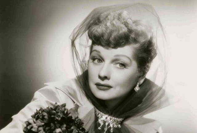 American actress Lucille Ball holding flowers
