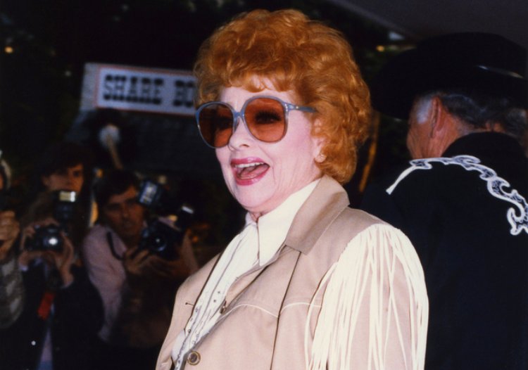 Lucille Ball attending a celebrity event in a pink outfit