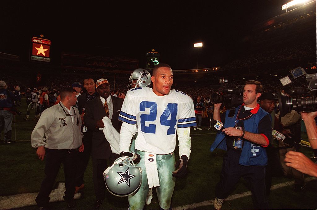 Cornerback Larry Brown of the Dallas Cowboys is swarmed by the media
