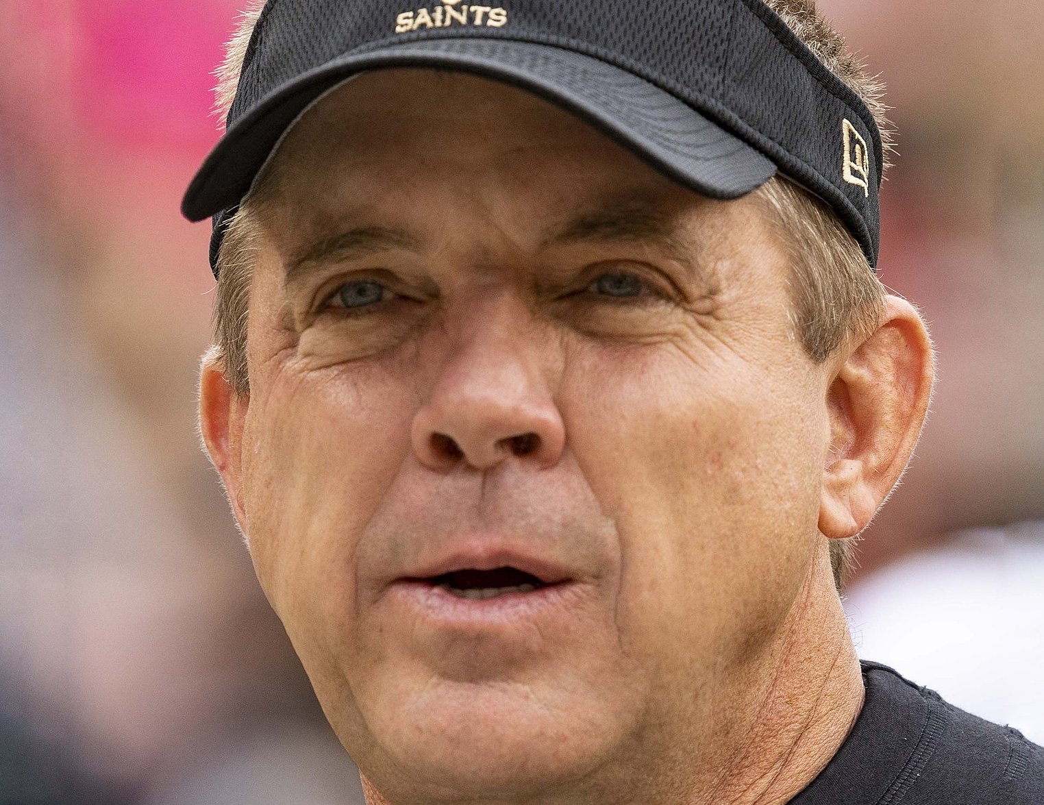 Sean Payton wearing black shirt and cap