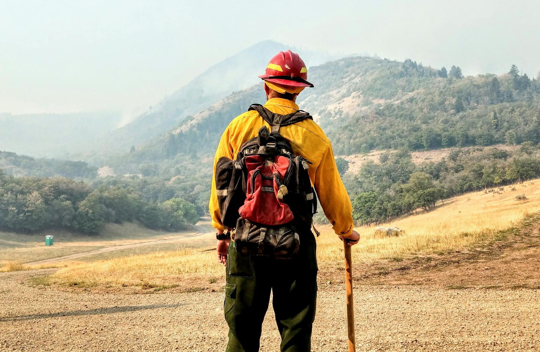 Man watching over hills in a field