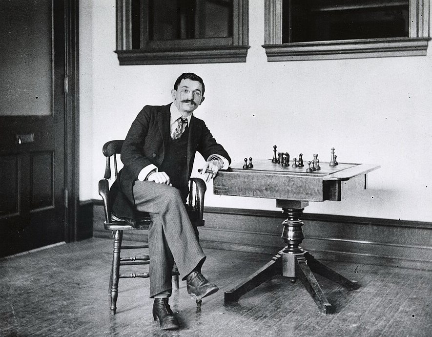 Photo of Emanuel Lasker with a chess board 