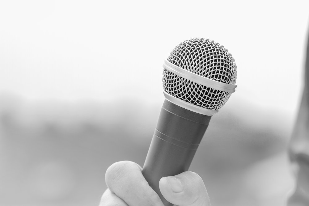 Hands holding microphones for speech speaking or interview