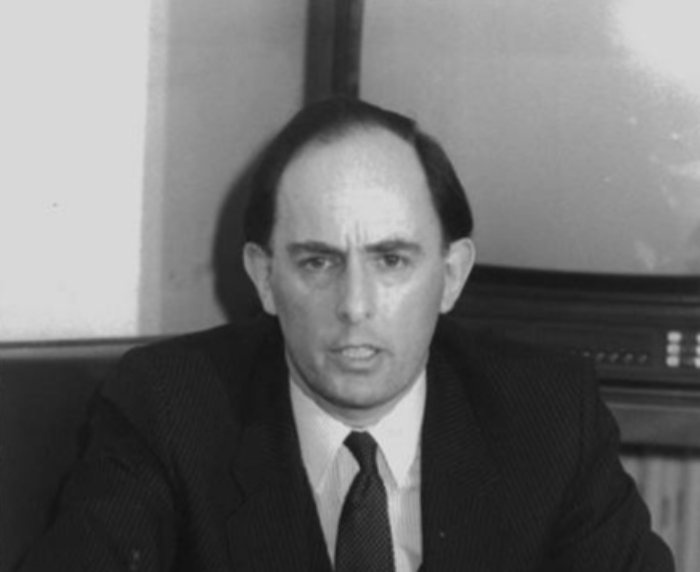 Grayscale Portrait Photo of Stephen Charles May in a dark suit