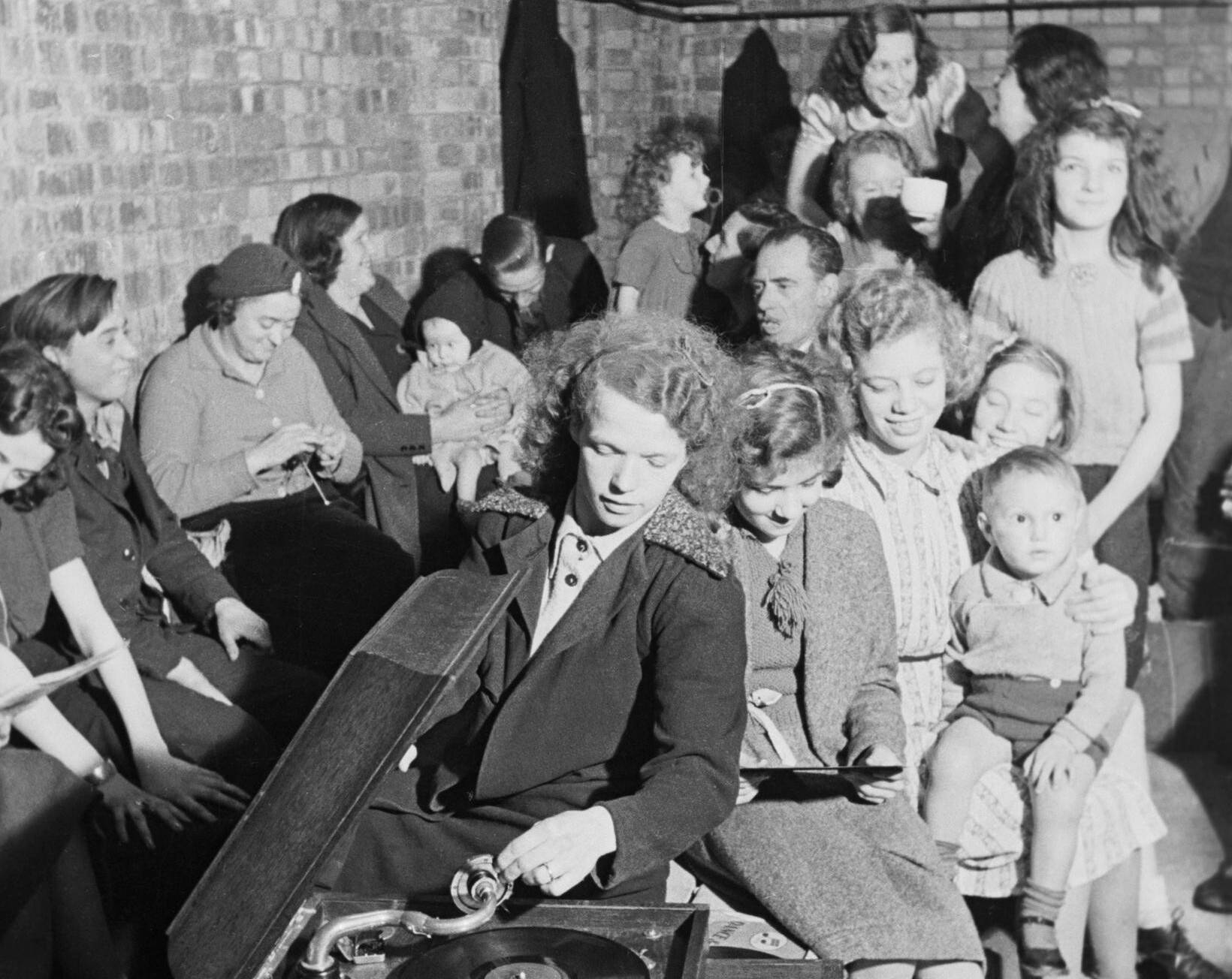A Young Woman Plays A Gramophone In An Air Raid Shelter In North London During 1940. D1631 (1)