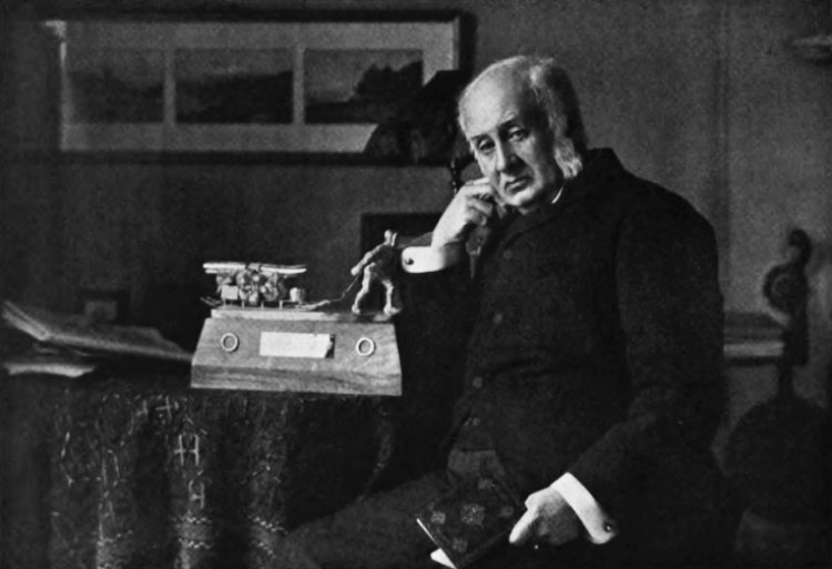 Sir Clements Robert Markham sitting and holding a book