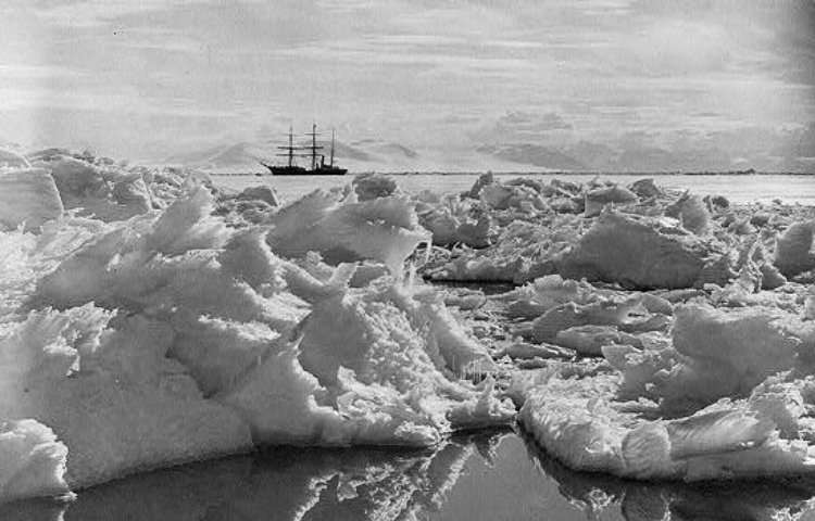Photograph shows sea ice in the foreground and the Terra Nova ship