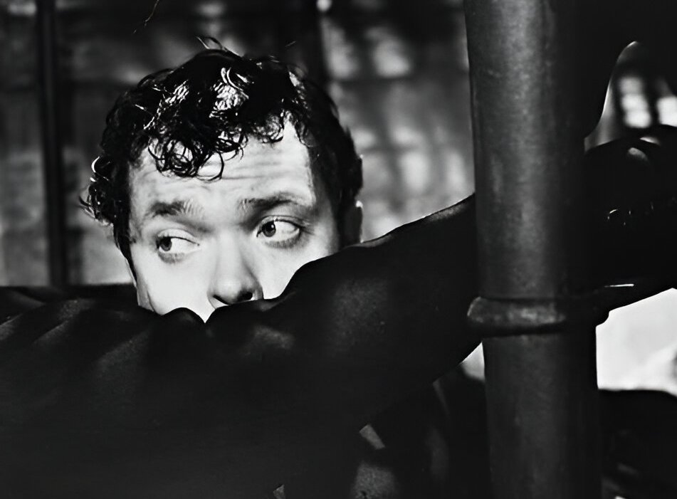 Orson Welles As Harry Lime Laying On A Staircase