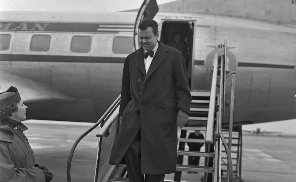 Orson Welles wearing a black coat