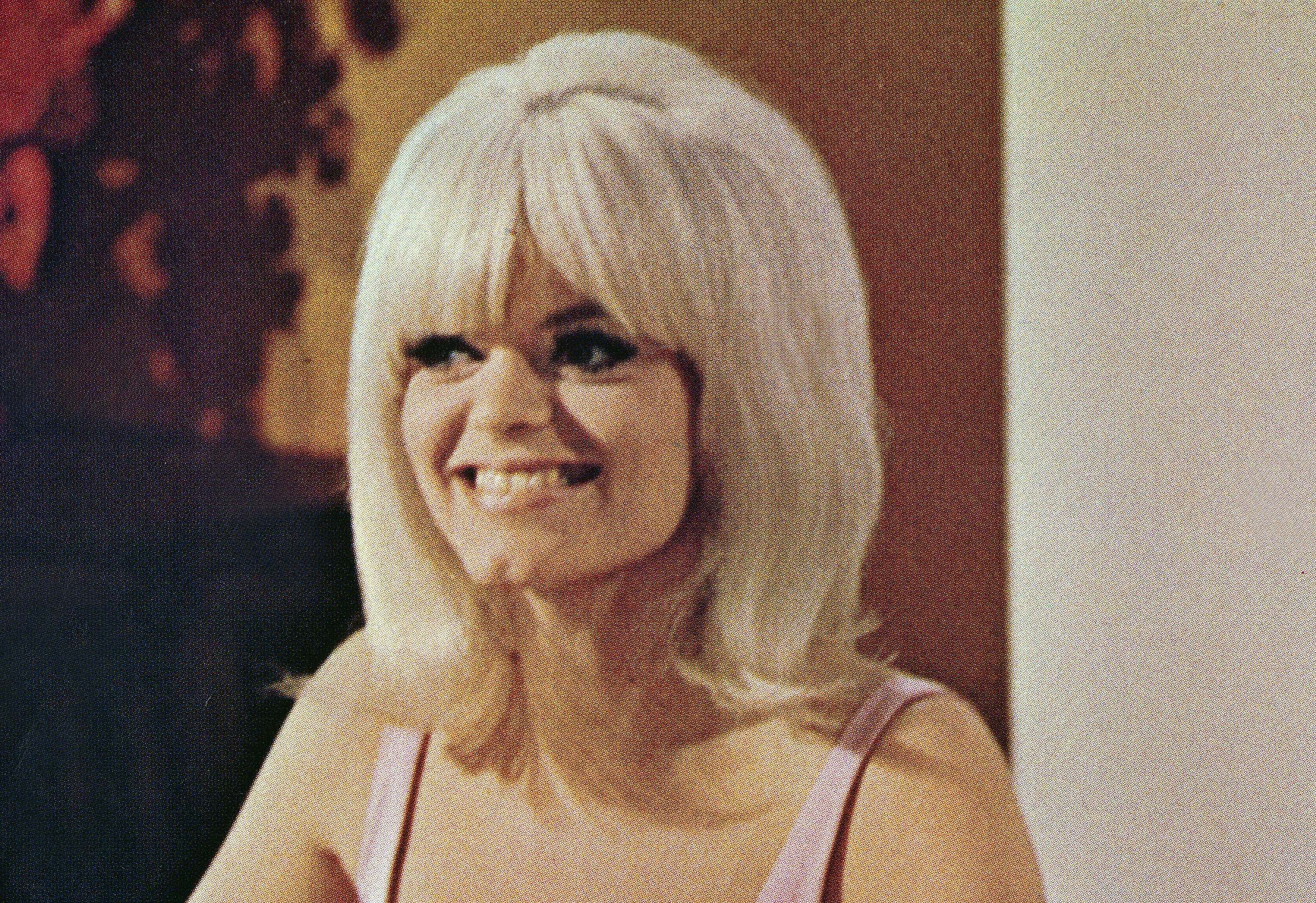 Carol Wayne smiling and looking away from the camera
