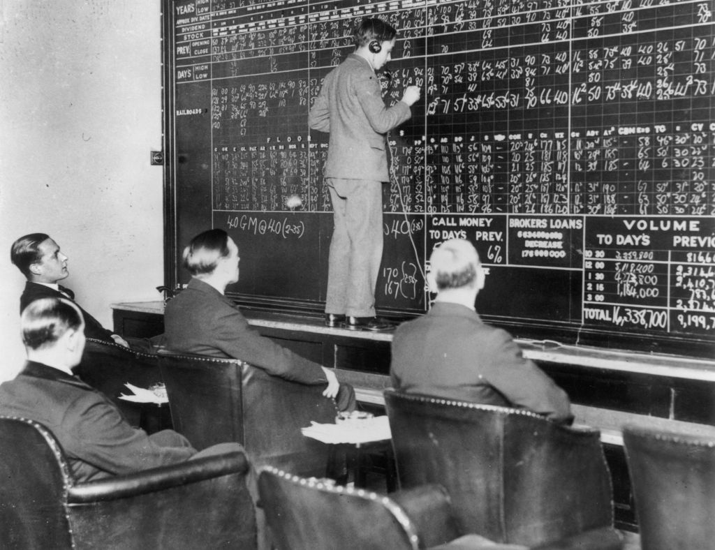 In a London club run by St Phalle Ltd, members watch fluctuations in the New York stock market during the Wall Street crash as changes are chalked up by telephone operators in direct contact with New York