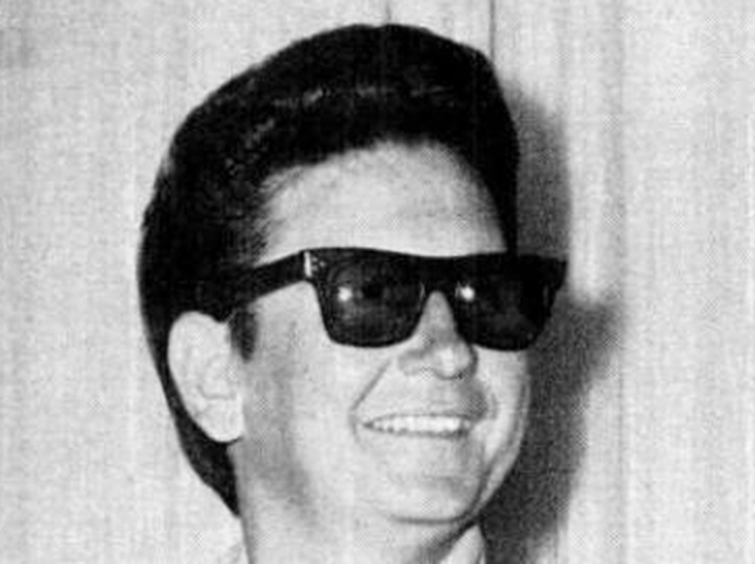 Roy Orbison looking at side and smiling - 1965