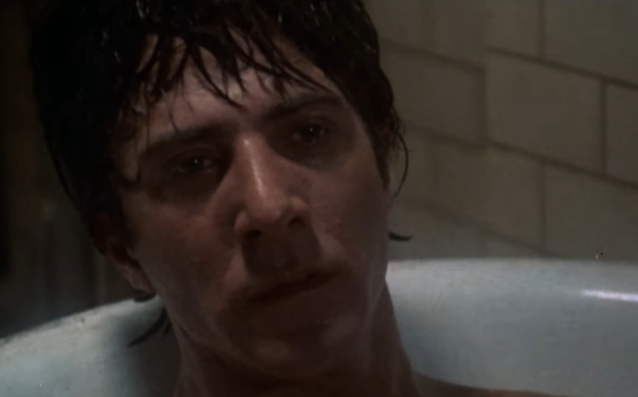 Dustin Hoffman laying in a bathtub 