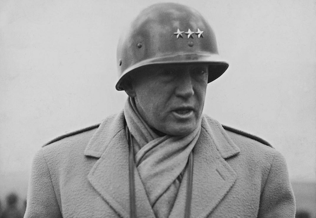 Photo of George S. Patton wearing  a helmet