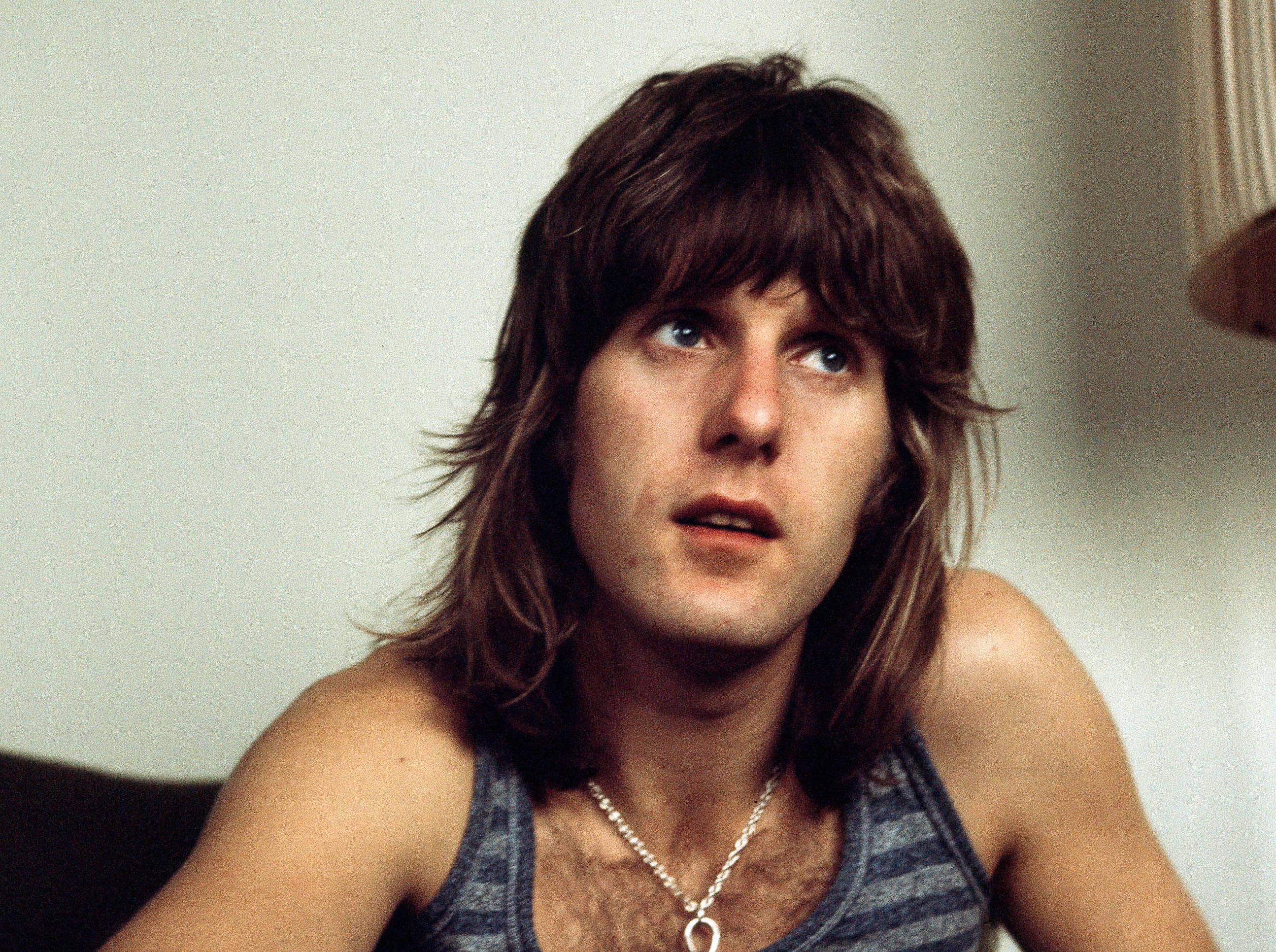 Keith Emerson of Emerson, Lake & Palmer sitting on couch