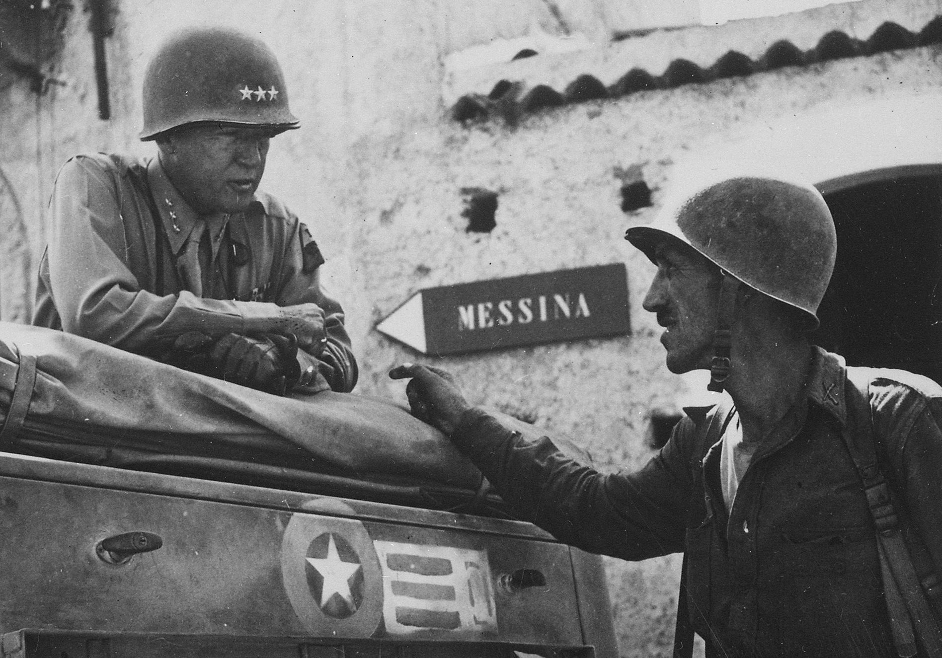 Lieutenant Colonel Lyle W. Bernard, commanding the 2nd Battalion, 30th Infantry Regiment, in conversation with Patton
