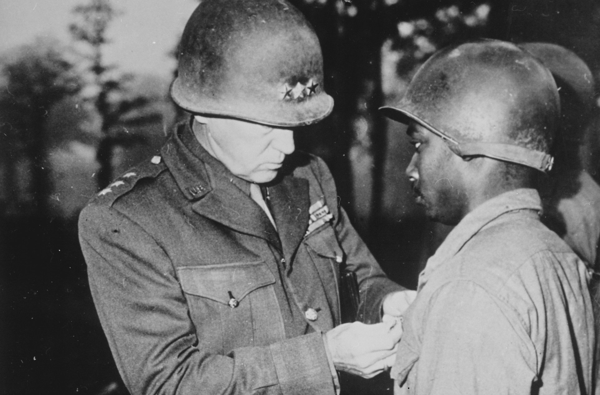 Patton pins a Silver Star Medal on Private Ernest A. Jenkins, a soldier under his command