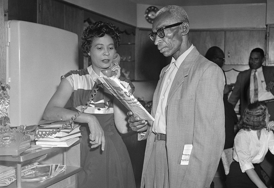 Mr. and Mrs. L.C. Bates in their home
