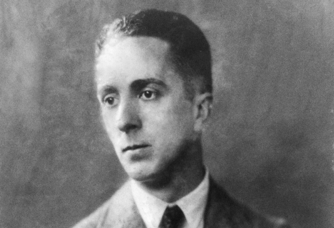 Norman Rockwell, half-length portrait, facing left, arms folded