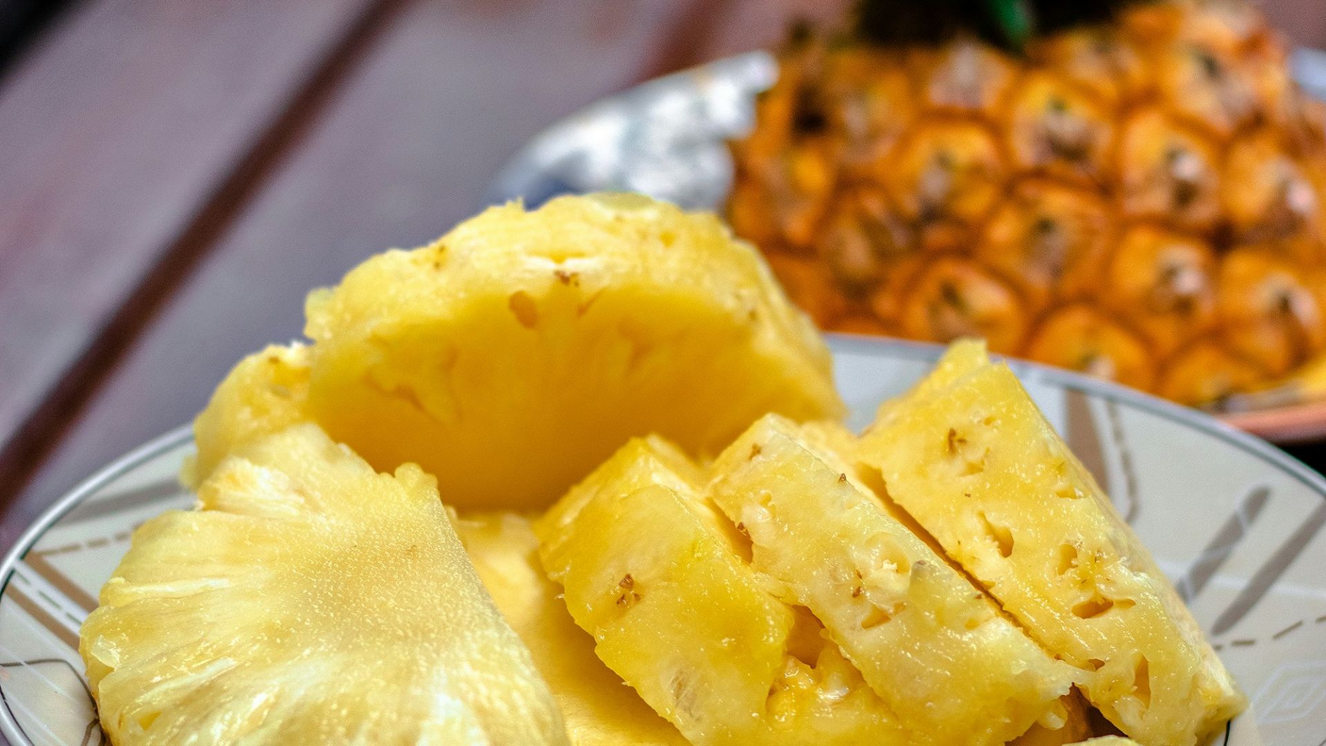 sliced pineapple on white ceramic plate