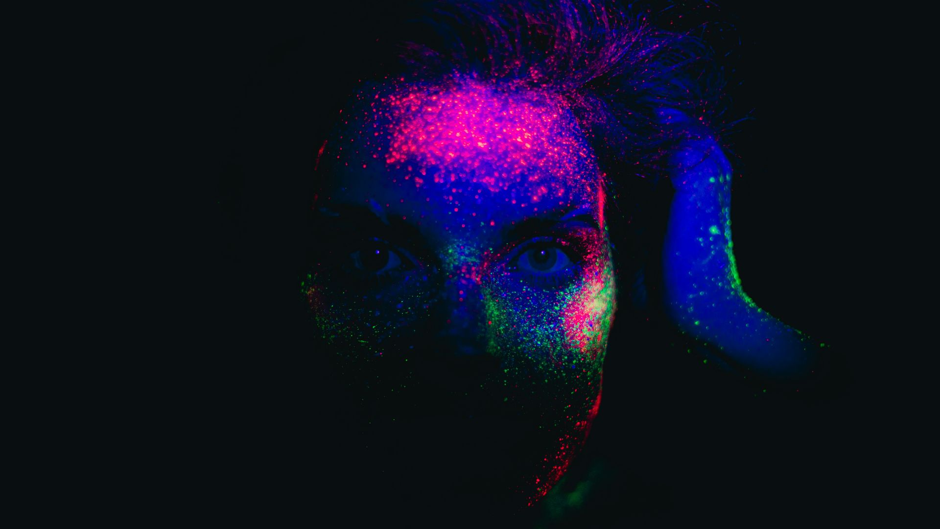 a woman with a blue and pink hair and a black background