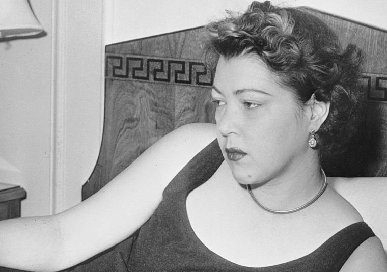 Diana Barrymore Looking at Photos of Deceased Uncle