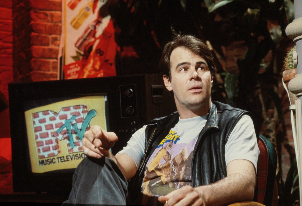 Dan Aykroyd sitting on a chair