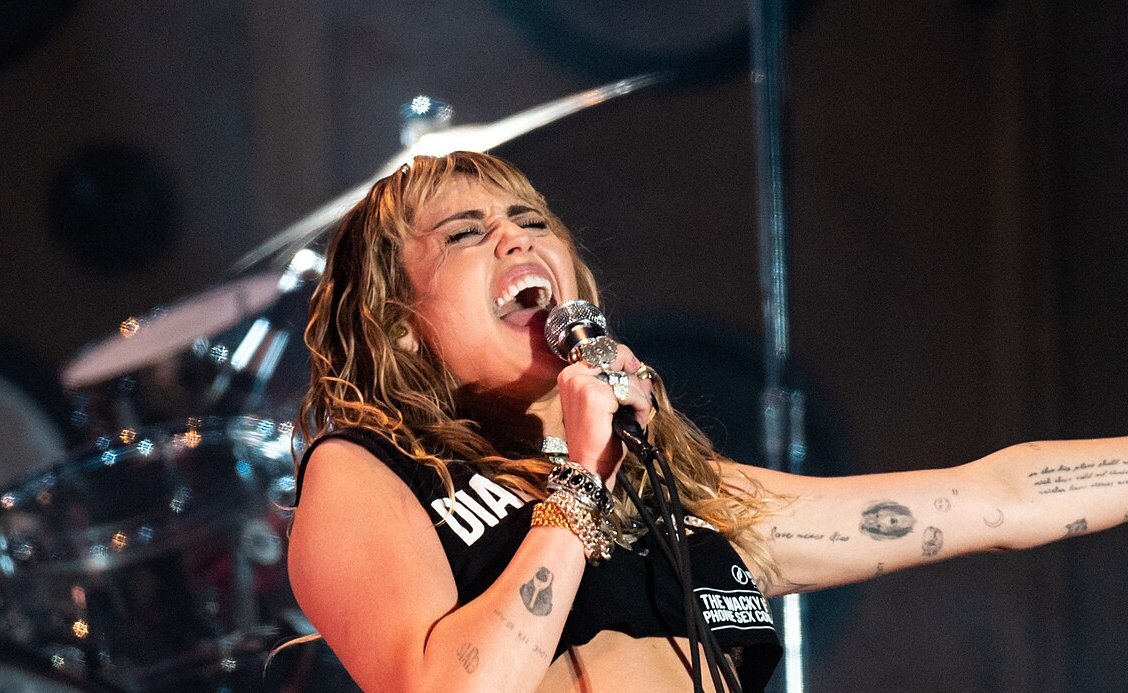 Miley Cyrus in black outfit performing on stage