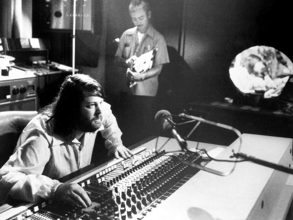 Promotional photo of Brian Wilson behind a mixing board