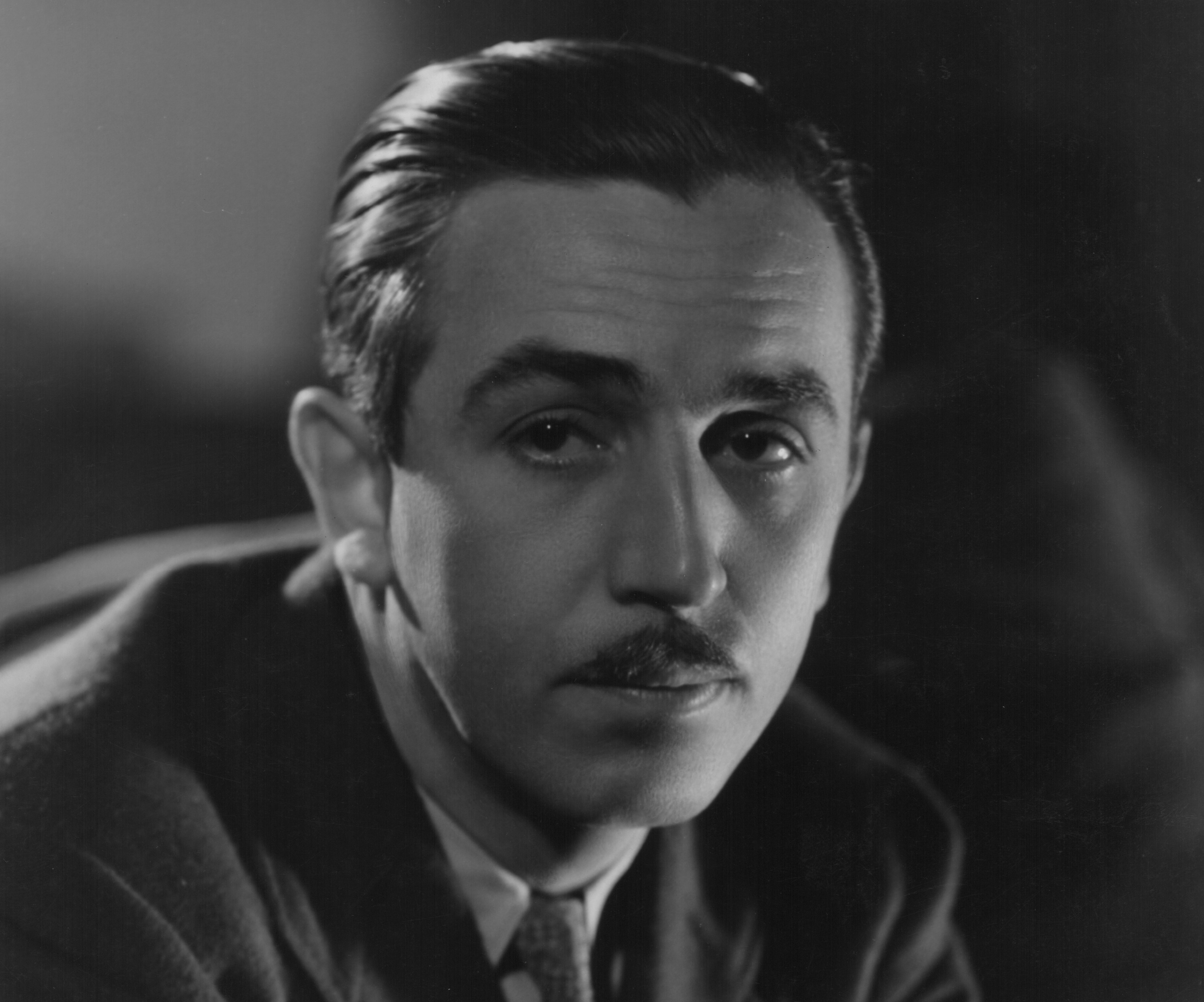 Grayscale Portrait Photo of American animator and film producer Walt Disney.