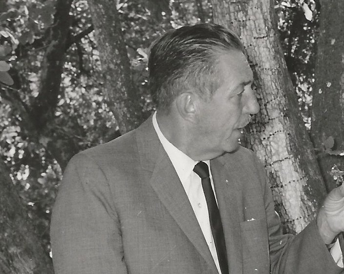 Grayscale Portrait Photo of American animator and film producer Walt Disney.