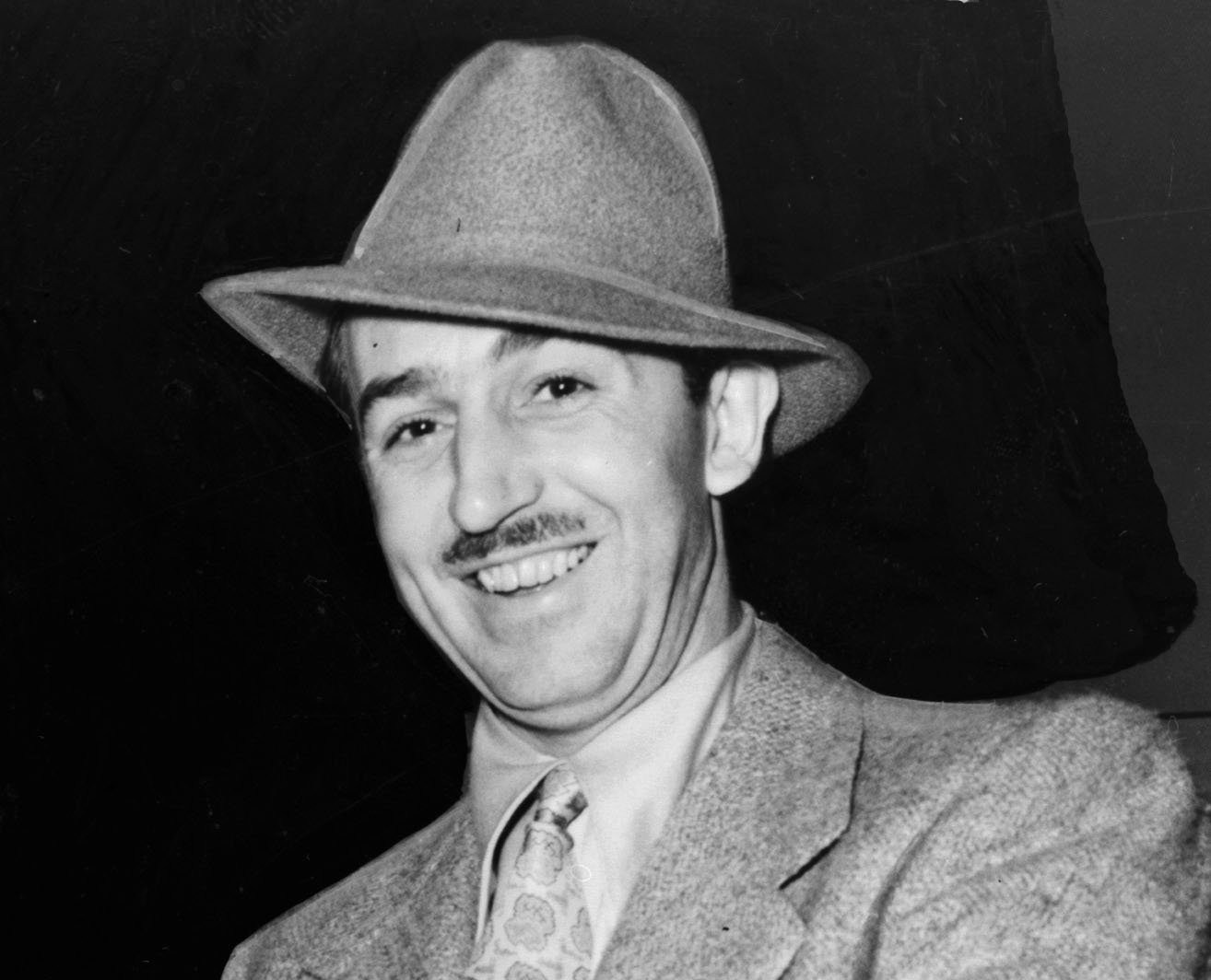 Grayscale Portrait Photo of American animator and film producer Walt Disney.