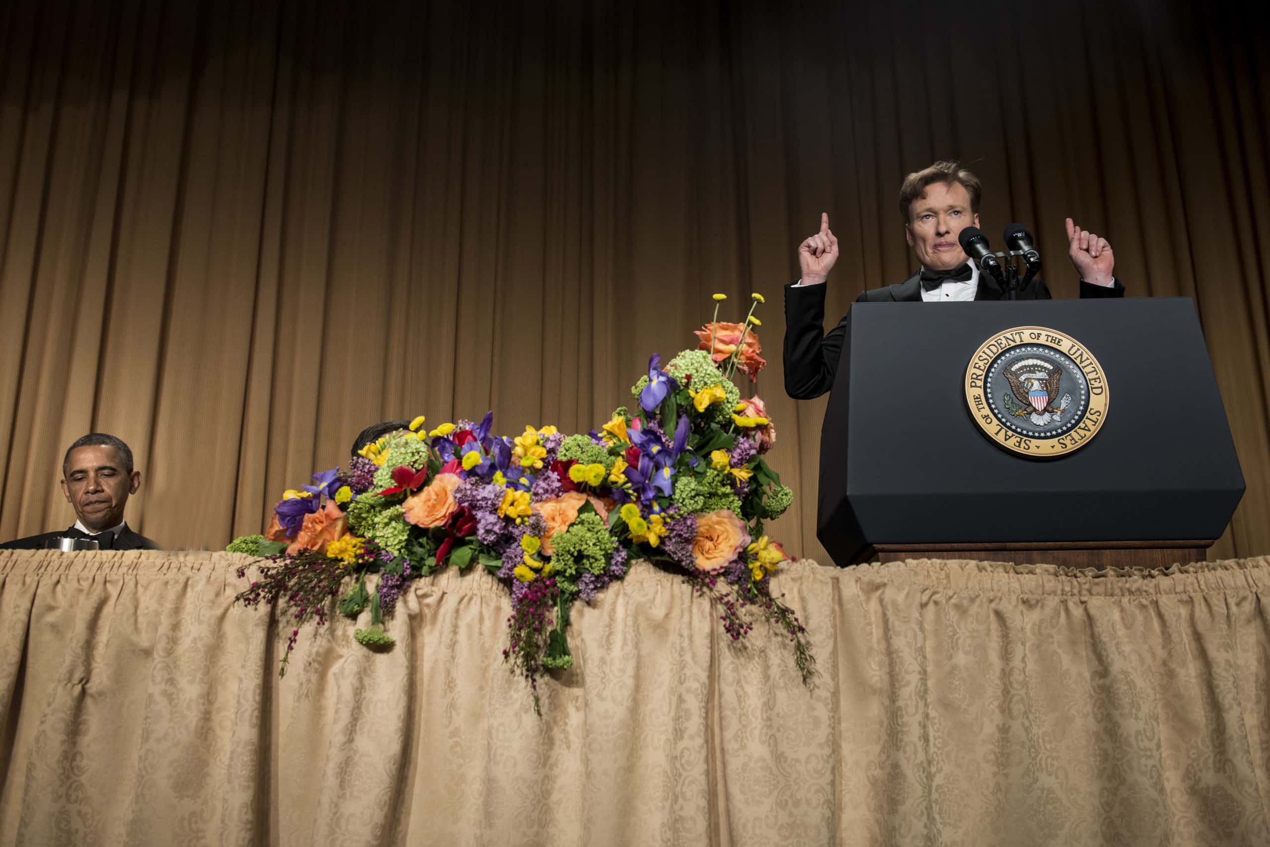 US President Barack Obama listens as Comedian Conan O'Brien