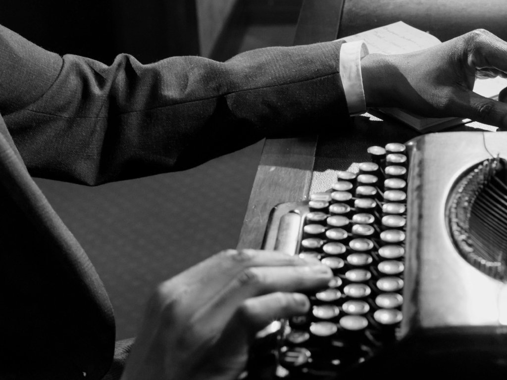 Close up Photo of Person Using Vintage Typewriter
