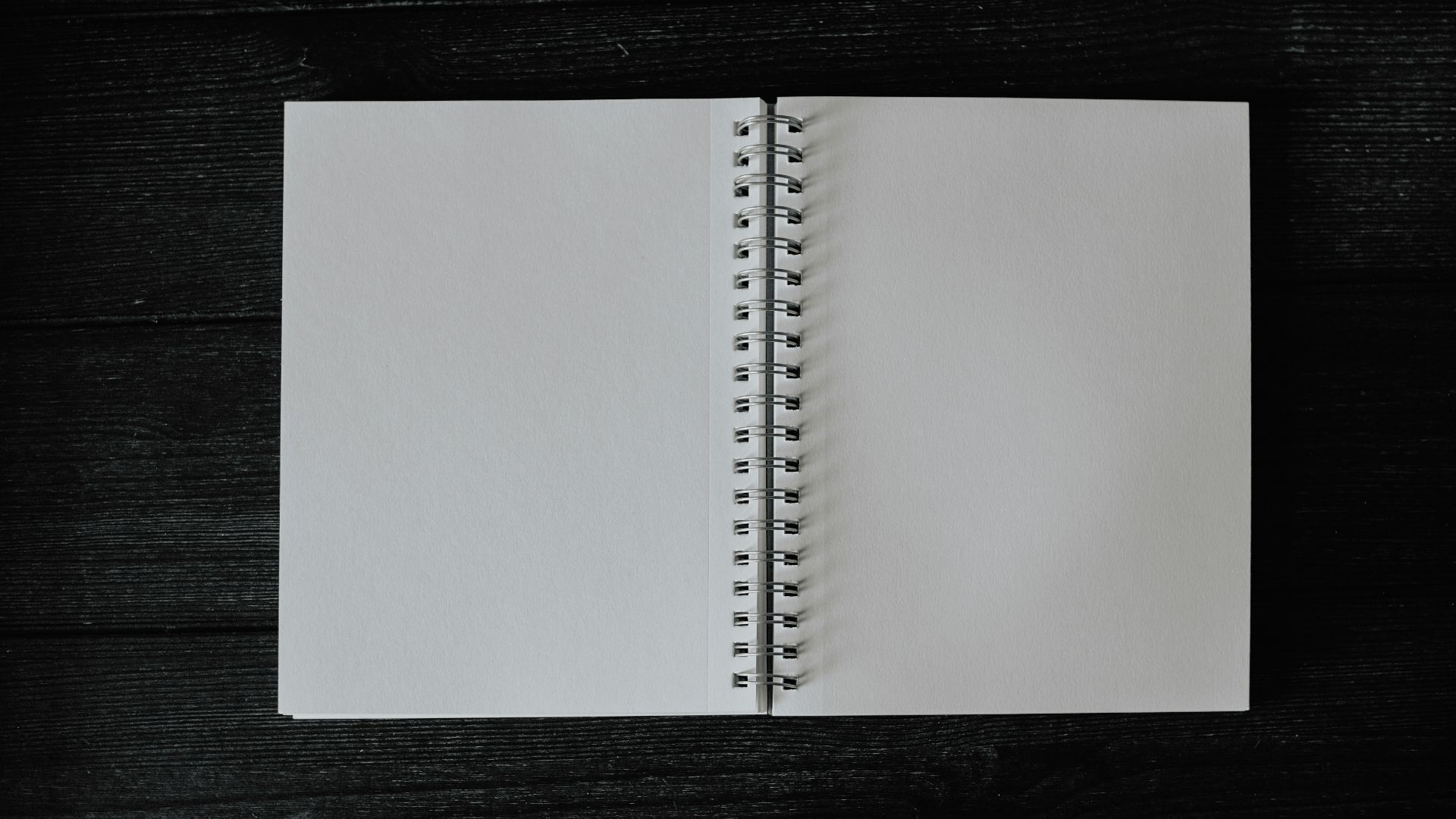 an open notebook on a wooden table
