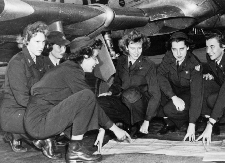 WASP (Women Air Force Service Pilot) students studying their flight plan for the day