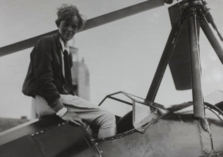 Amelia Earhart sitting in an airplane
