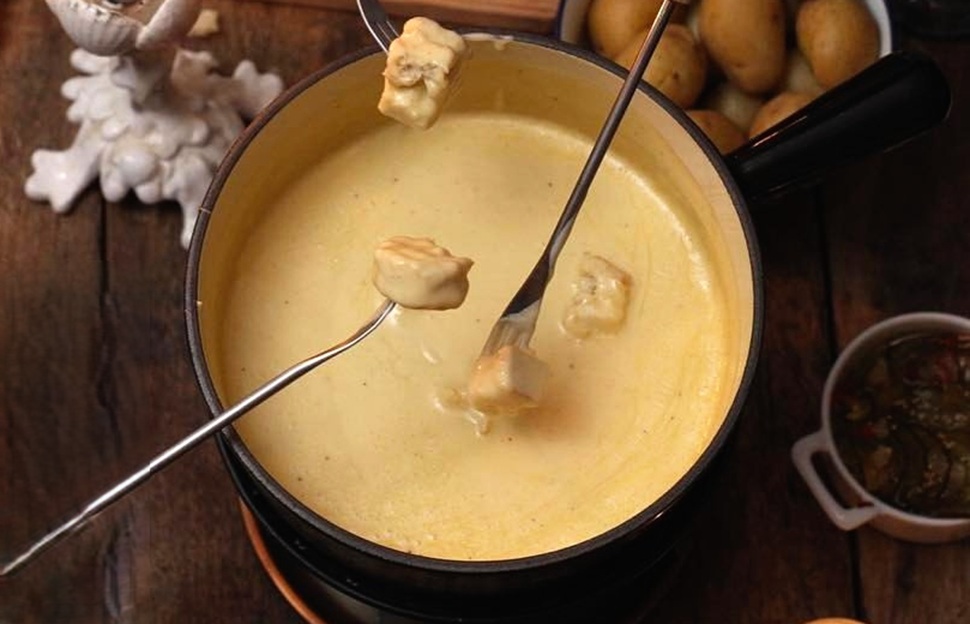 Fondue served with bread, potatoes