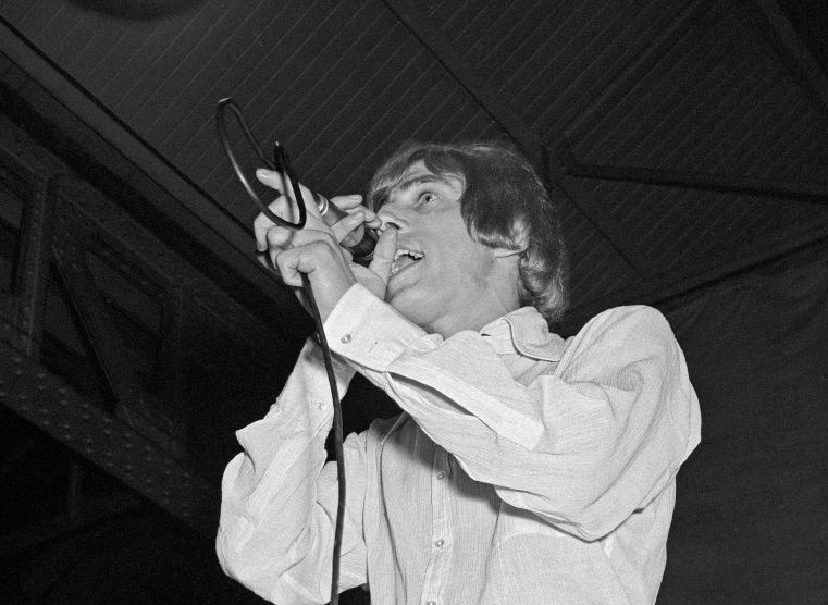 Grayscale Portrait Photo of Roger Daltrey of The Who performs on stage